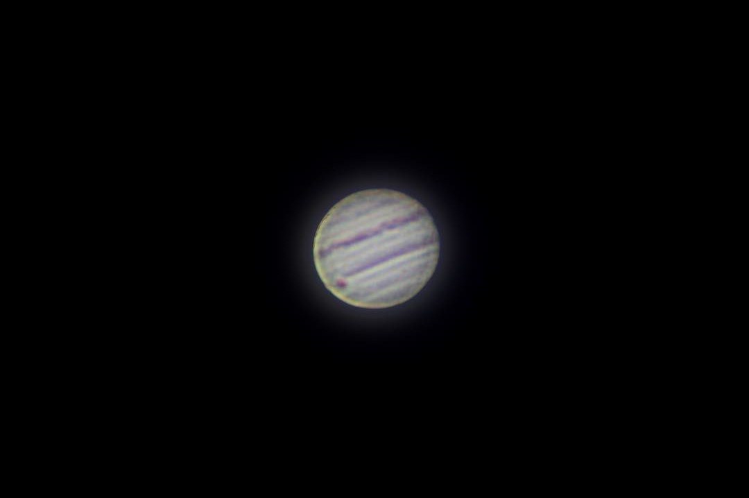 Jupiter with cloud bands and the shadow of Io transiting the disc