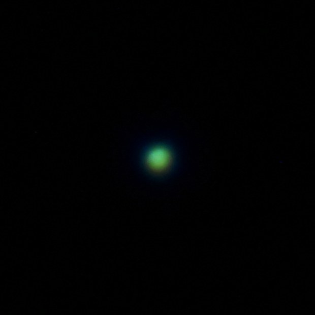 Uranus as a small pale green disc